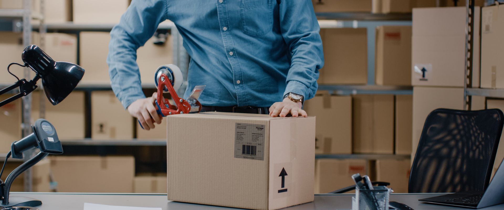 Homem embalando caixa para entrega